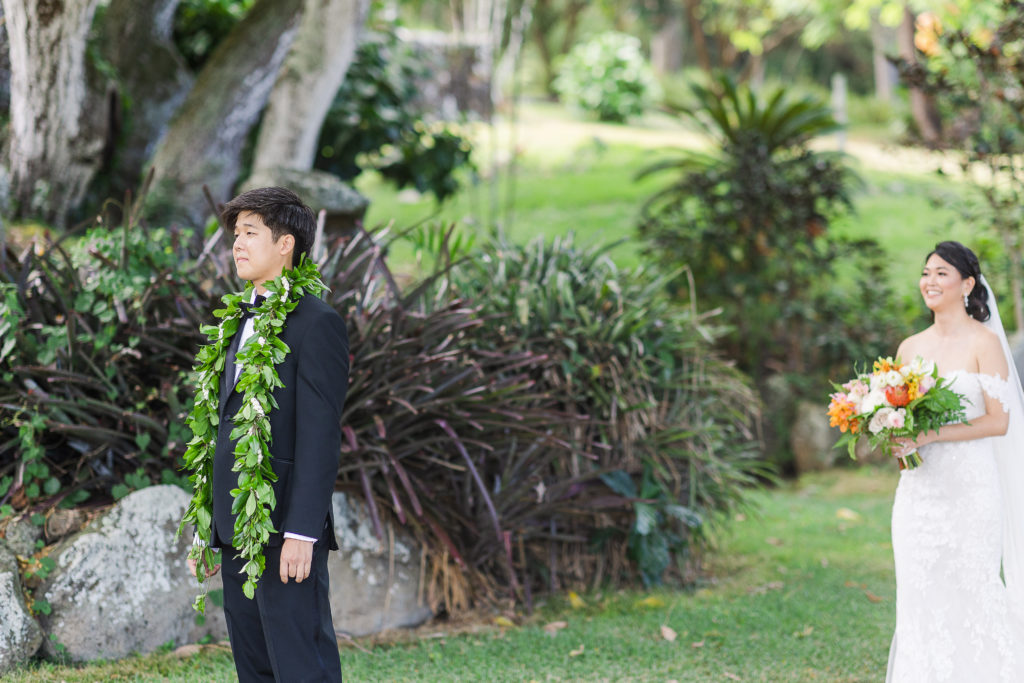 Bride and groom sharing a first look at the Paliku Gardens in Kualoa Ranch