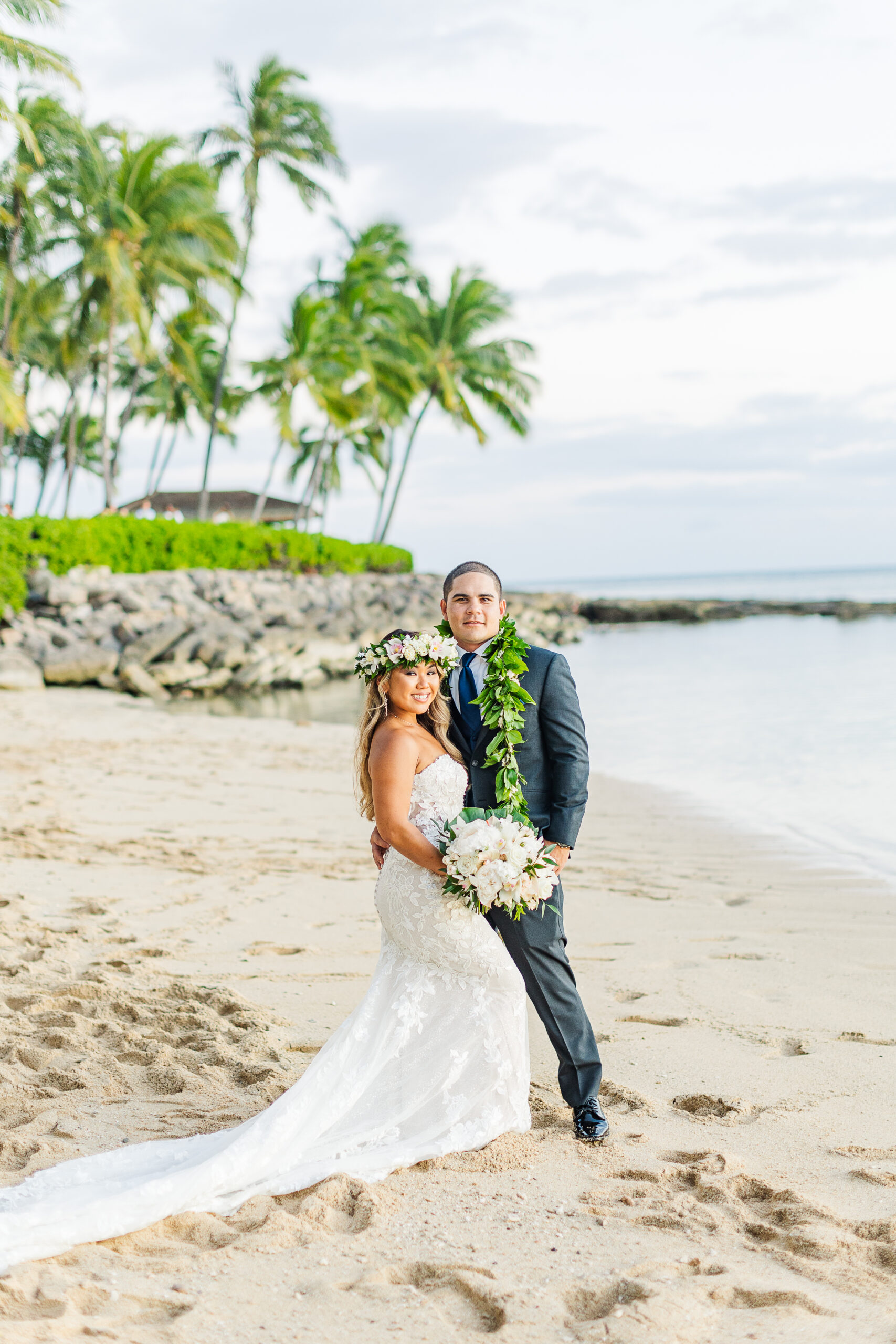 couple posing on beach at lanikuhonua